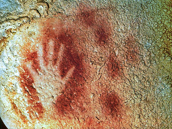 Stencil of hand on cave wall