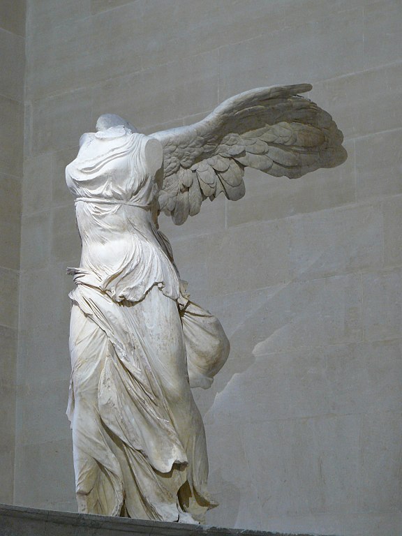 statue of headless, armless woman with wings