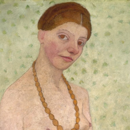 Woman with hair up, amber necklace, and no clothes above the waist