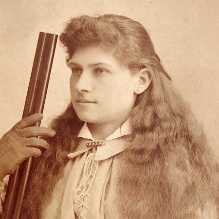 Woman with long hair and gun