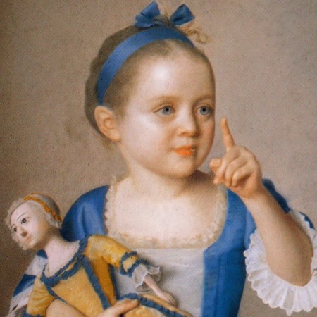 Girl in fancy dress holding a doll in fancy dress