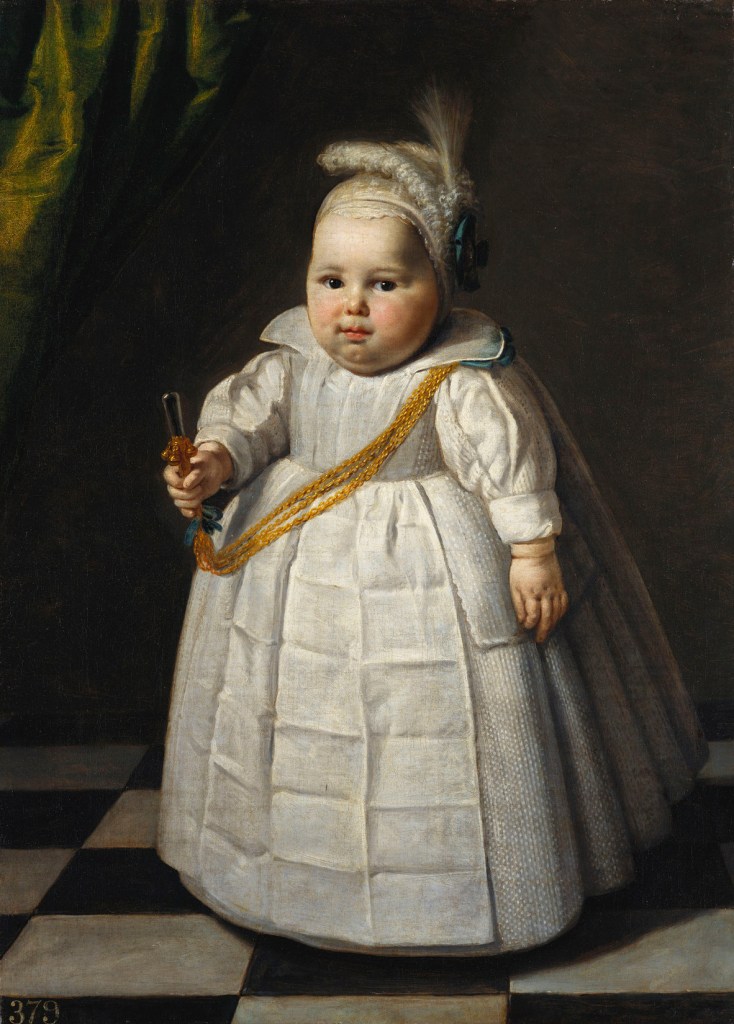 Toddler in white dress and bonnet